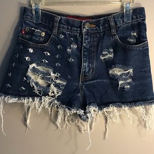 Blue ripped jean shorts with silver accents
